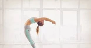 Raising arms in Ardha Chakrasana